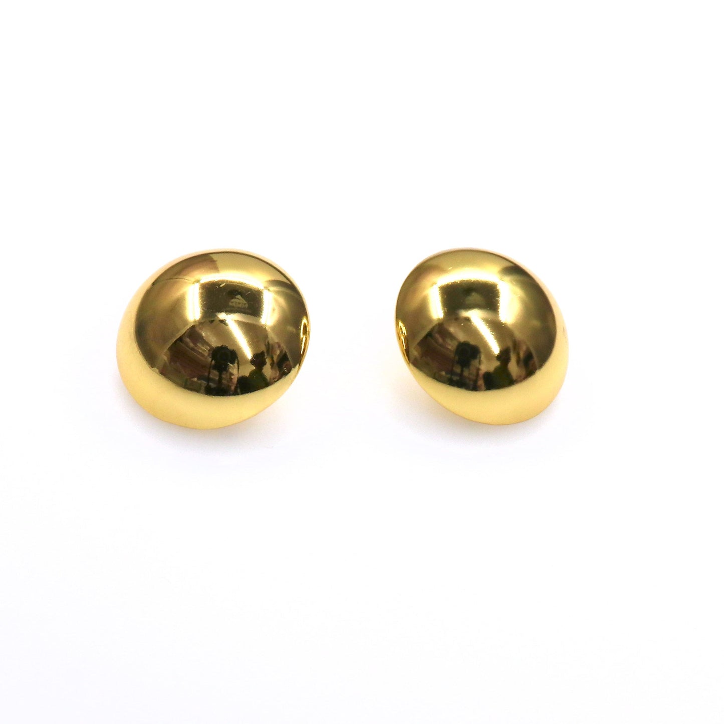 Pair of gold chunky half ball lightweight earrings on white background