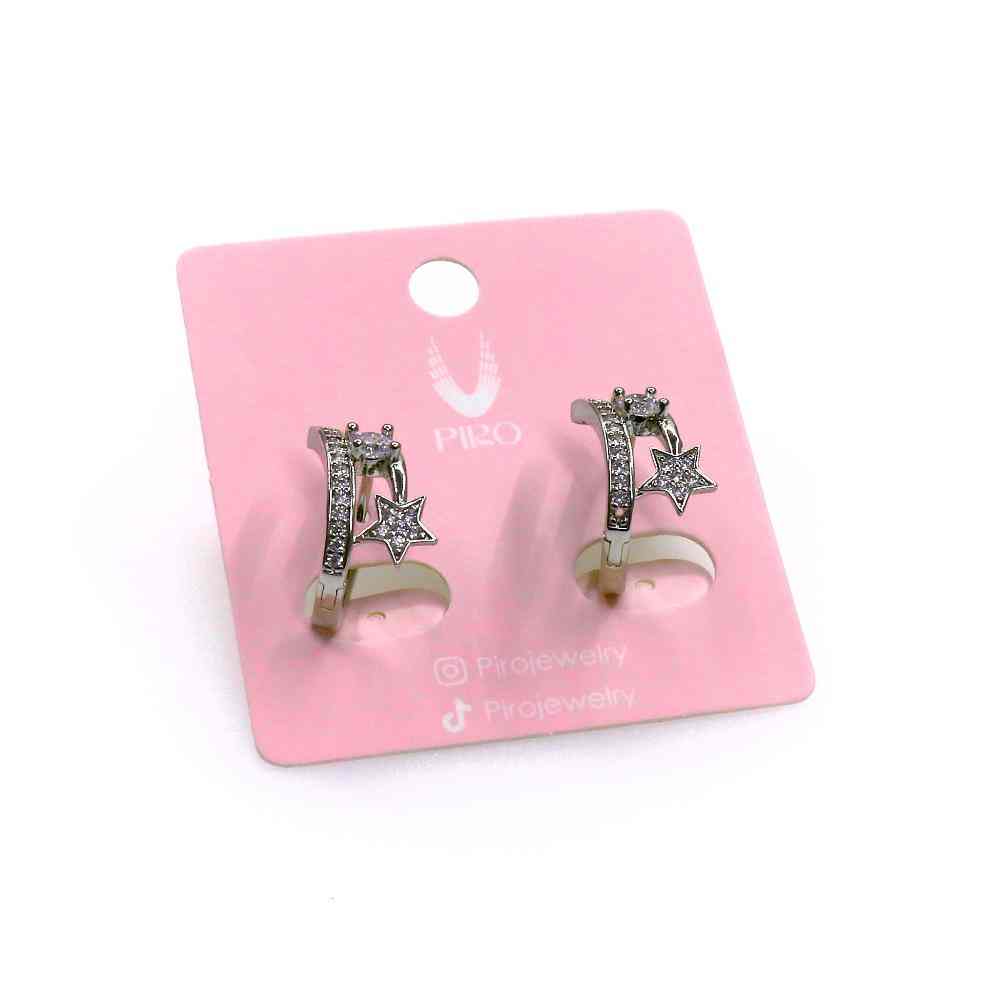 Silver star-shaped STAR HUGGIE earrings with rhinestone accents on a pink display card