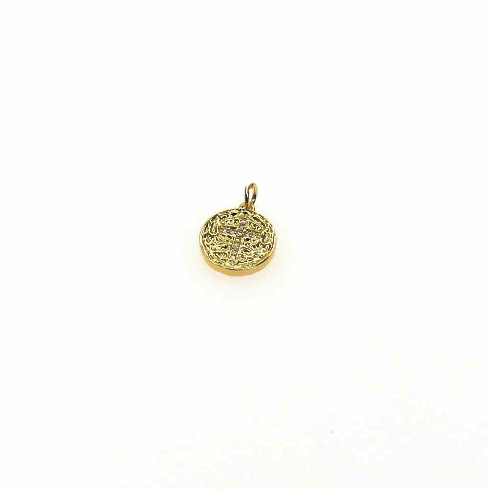Small gold pave cross medallion with intricate detailing on white background