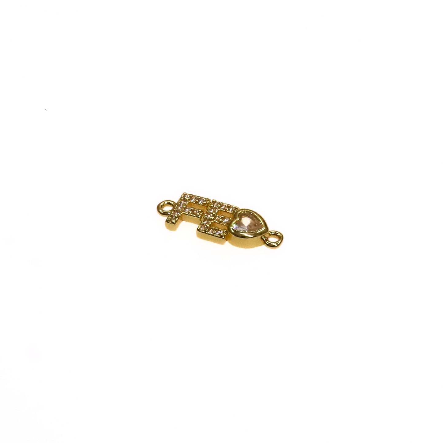 gold FE CHARM pendant with embedded stones and heart detail isolated on white background