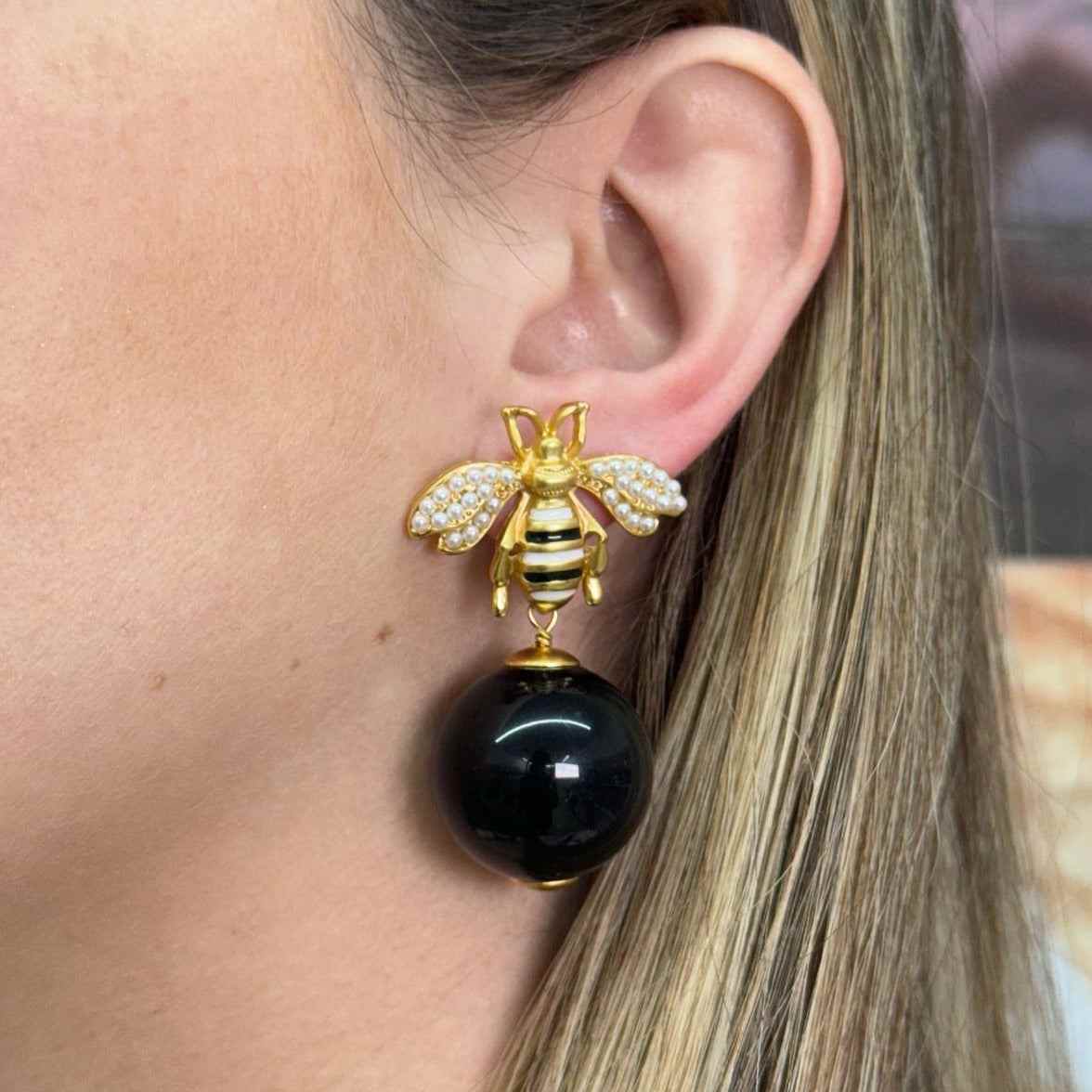 Close-up of ear wearing gold-filled vintage-inspired DINASTIA earring with bee design and