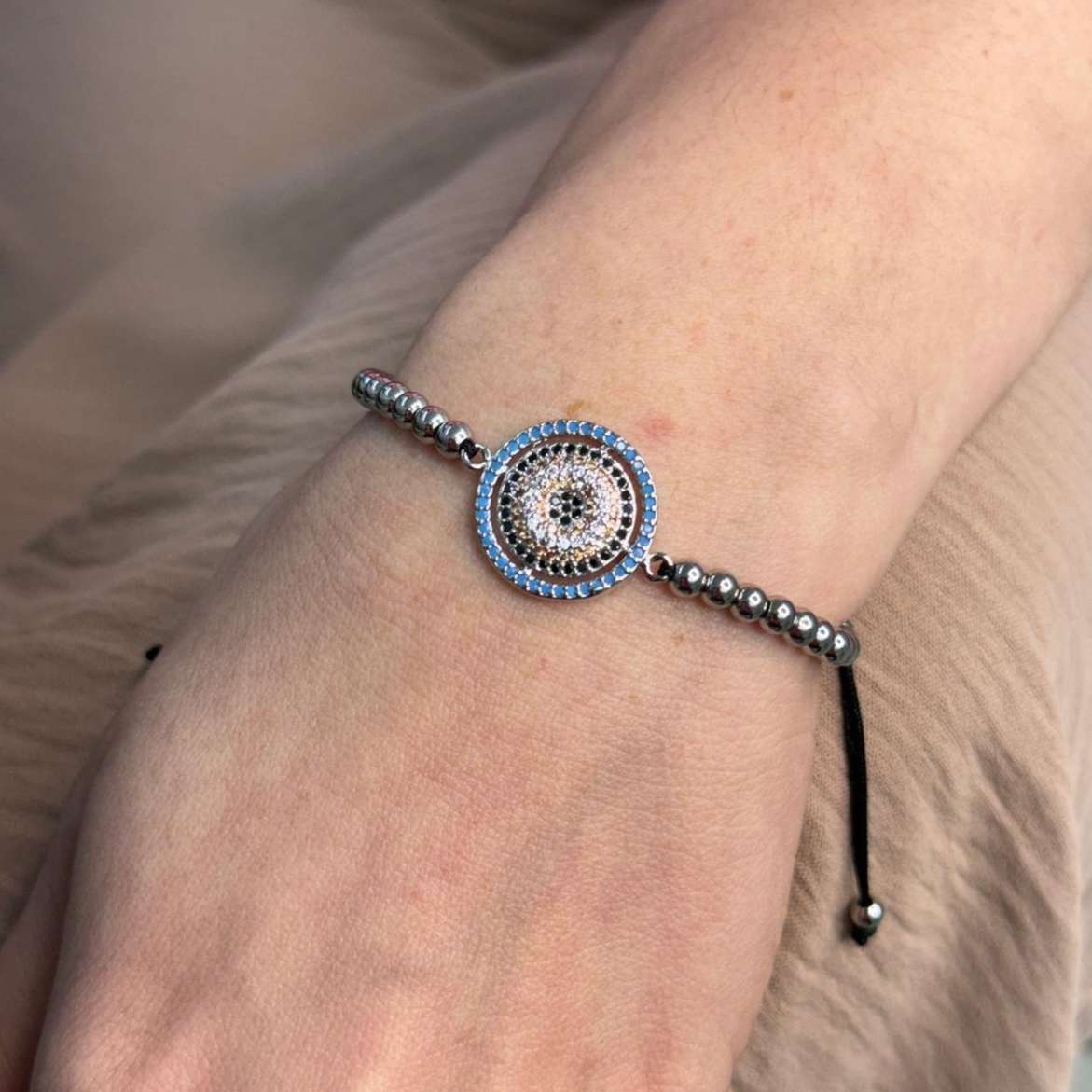 Adjustable big eye slider bracelet with beaded design on wrist, stylish and durable accessory