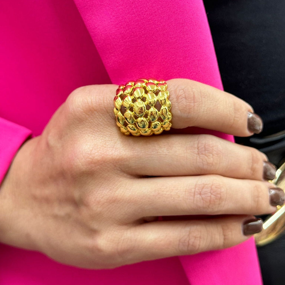 Gold adjustable DOME BEADS RING with modern dome bead design on hand against pink sleeve