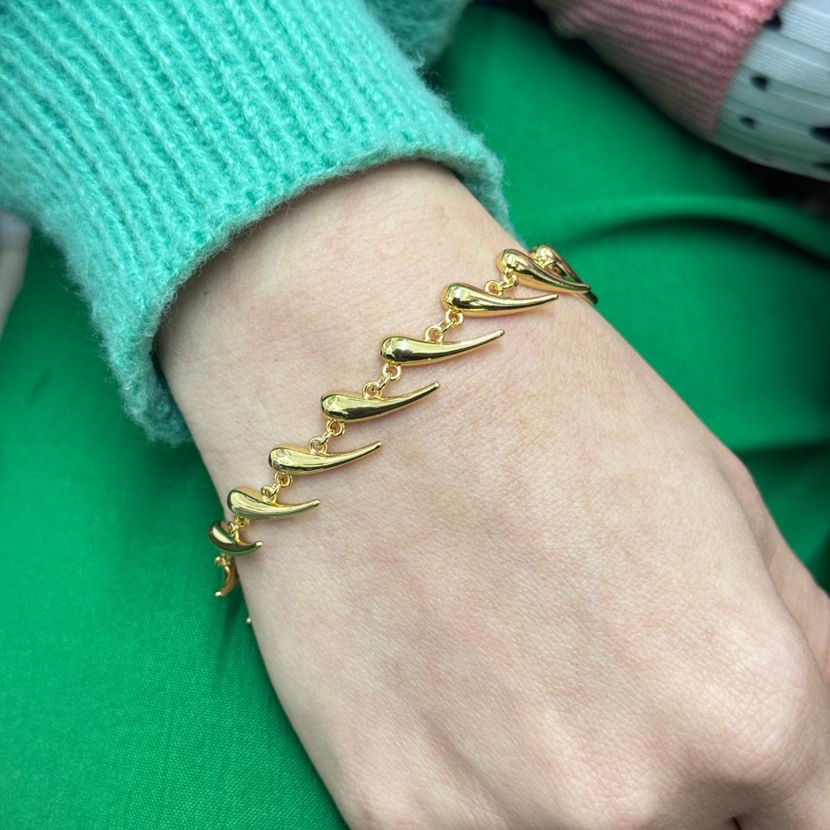 Golden Horn Bracelet with linked golden horn-shaped charms on wrist