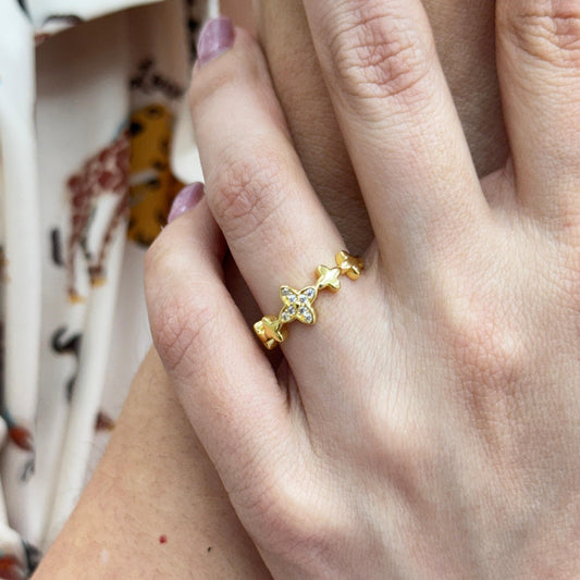 Gold ring with star design on a person's finger