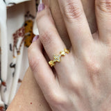 Gold ring with star design on a person's finger