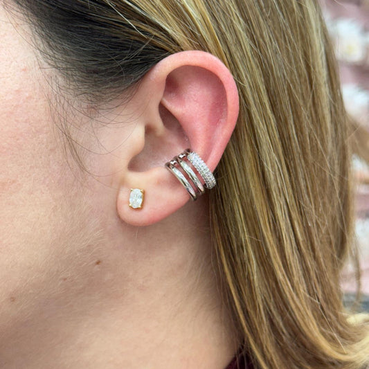 Close-up of an ear with a silver earring and a blurred background