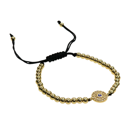 Small Evil Eye bracelet with gold beads, silver circle eye charm, and adjustable black slider bead cord