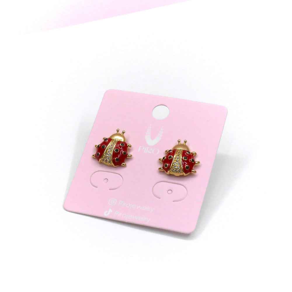 Ladybug stud earrings on display card, featuring intricate details and elegant design.