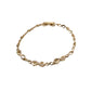 Gold bracelet with intricate designs on a light purple background