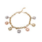 Gold filled bracelet with three-color trebol charms in yellow, rose, and white gold tones.