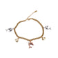 Gold bracelet with various charms on a white background