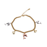 Gold bracelet with various charms on a white background