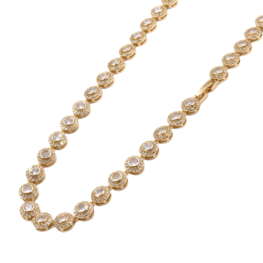 Gold necklace with diamond-like stones on a white background