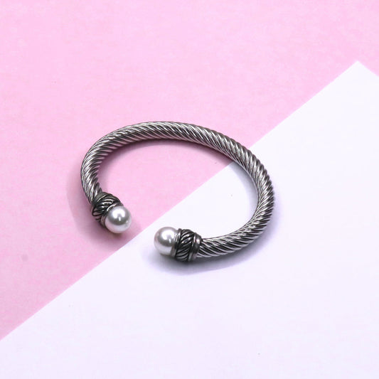 OSEA CHUNKY CABLE bracelet with two large pearls on ends on pink and white background