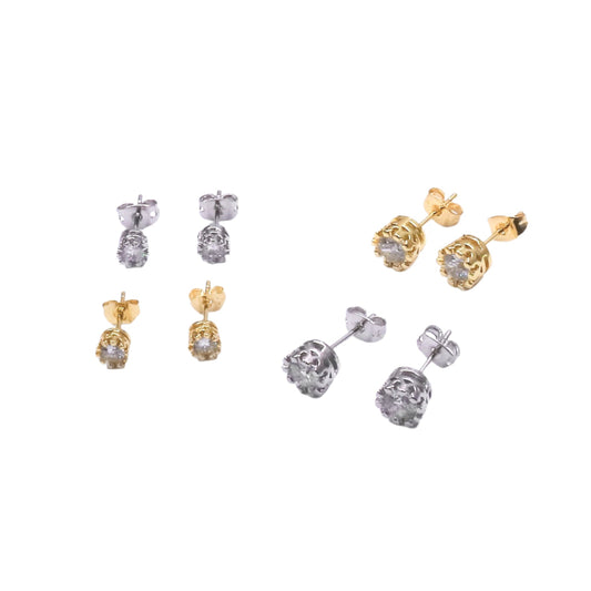 Set of gold and silver earrings on a white background