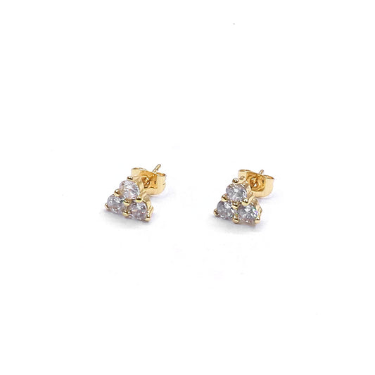 Gold and silver stud earrings on a white background