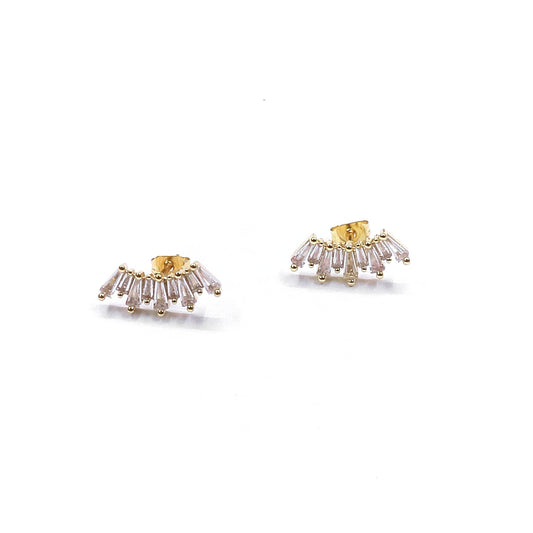 Gold and clear gemstone earrings on a white background