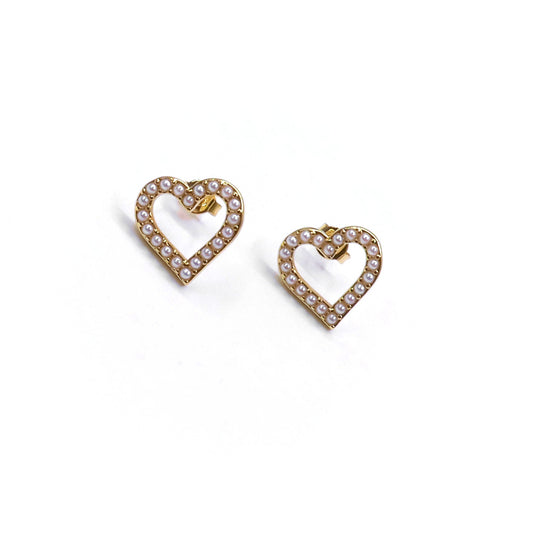 Heart-shaped earrings with pearl detailing on a white background