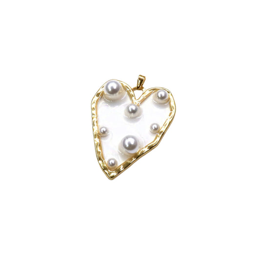 Heart-shaped pendant with pearls on a white background