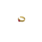 Gold ring with a red gemstone on a white background