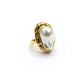 Gold ring with a large white pearl on a white background