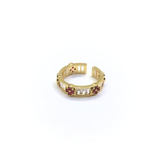 Gold ring with gemstones on a white background