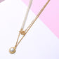Elegant Pearls Layering Chain necklace with gold accents and pearl pendant on white and pink background