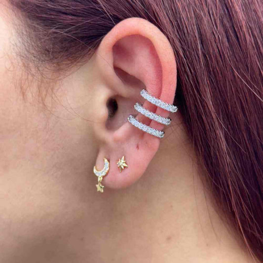 Elegant silver cuff with sparkling zirconia stones on ear.