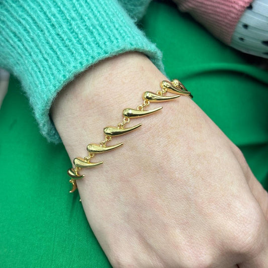 Golden Horn Bracelet with linked golden horn-shaped charms on wrist