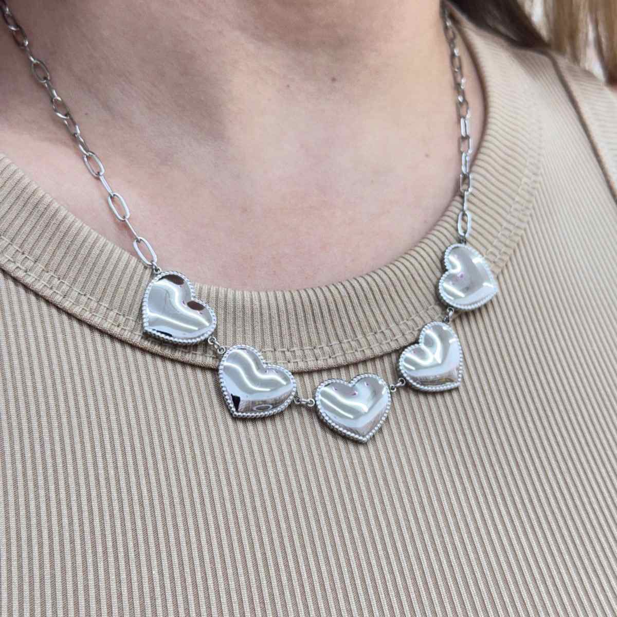 LOVE CHAIN with solid heart charms on a stainless steel golden and silver chain.
