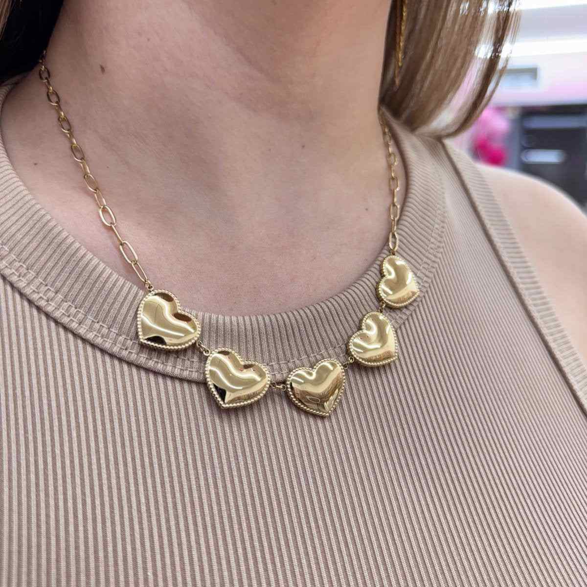 Stainless steel love chain with solid heart charms in gold and silver.