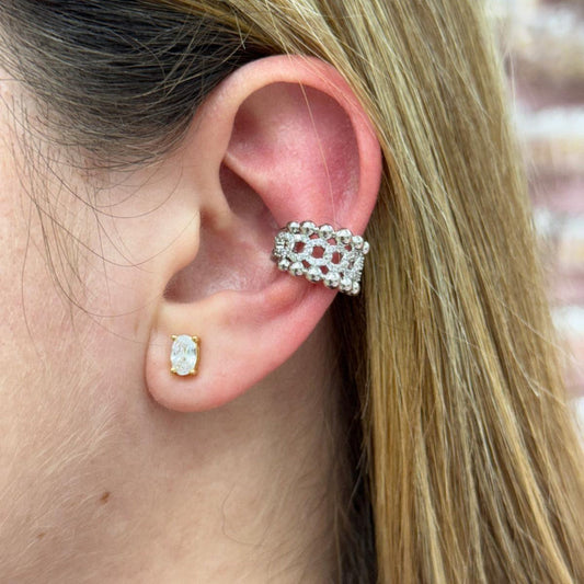 Close-up of an ear wearing a silver and gold tone gold-filled Beads Pave Cuff earcuff and a small gold earring with a clear stone.