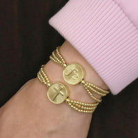 Slide bracelet with bead strands and religious medals faith & cross